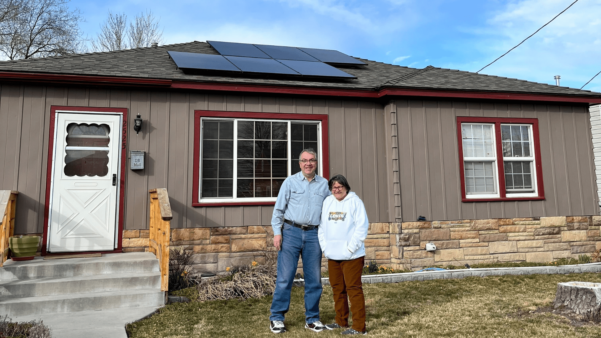 Customers standing in front of their solar system in Klamath Falls., Oregon